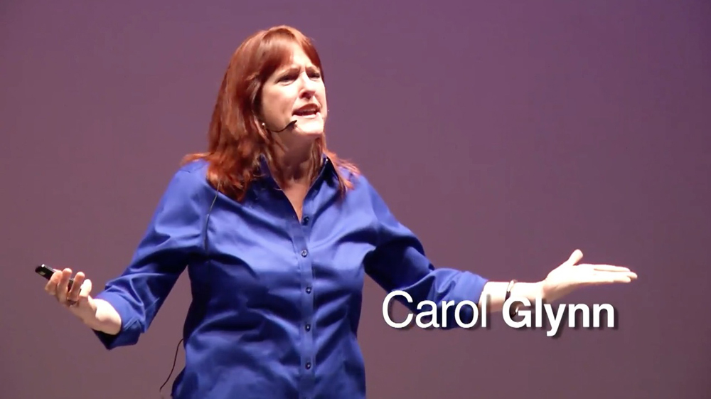 This is photo of Carol Glynn giving her talk “WHY MAKE THEM SIT STILL, WHEN THEY CAN LEARN ON THEIR FEET?” at TEDxCCSU.